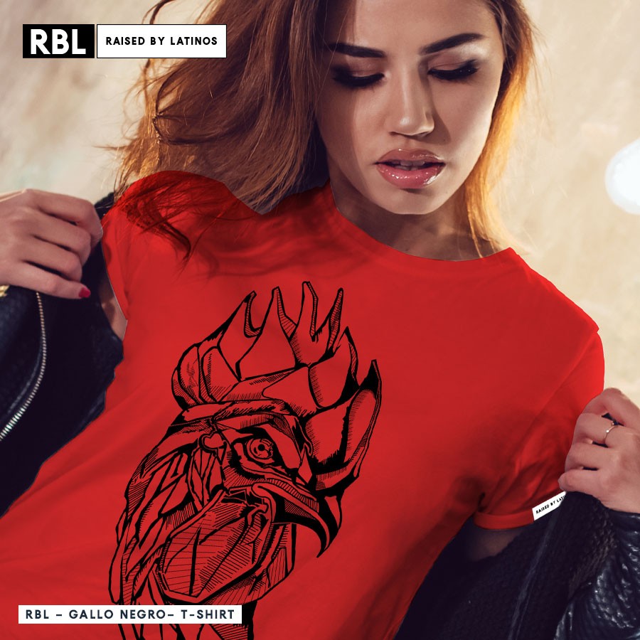 El Gallo Negro rooster head drawn in fine black linework on a red RBL t-shirt, worn by a model