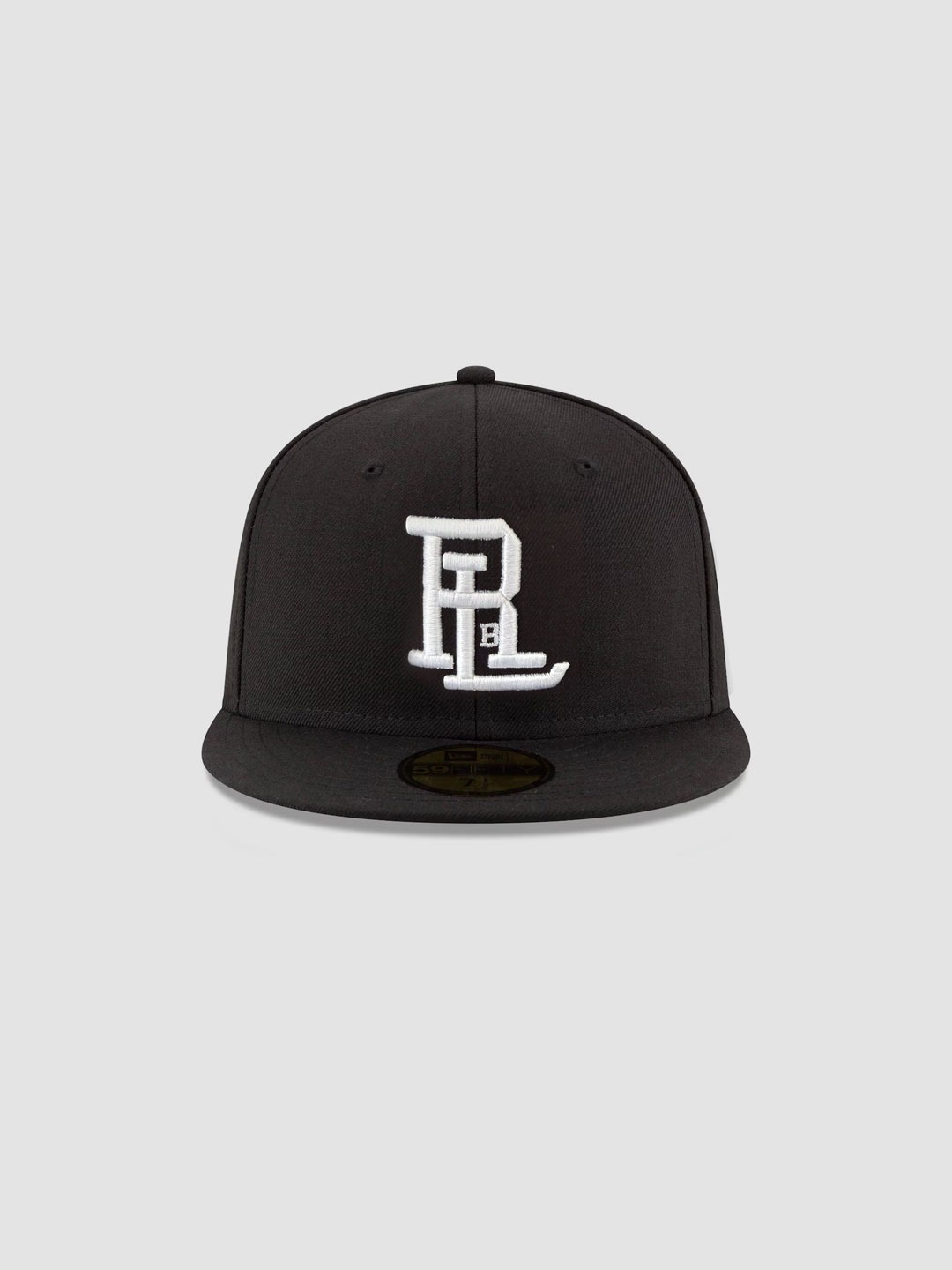 Raised By Latinos black New Era fitted cap with white RBL monogram, angled view