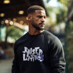 model wearing Champions latino streetwear hoodie with Raised by latinos text