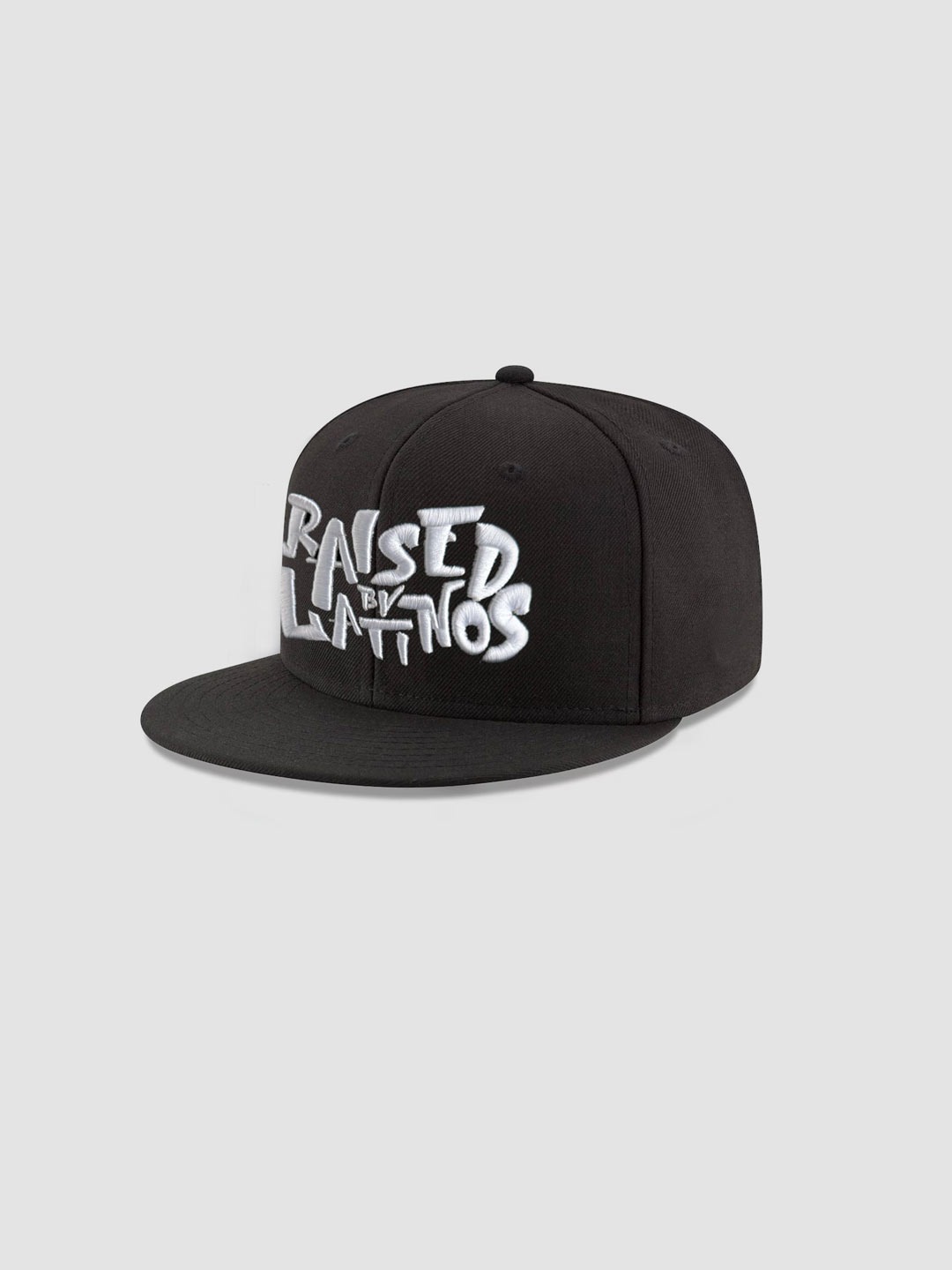 RBL Champions black cap with white graffiti-style RAISED BY LATINOS embroidery, angled view